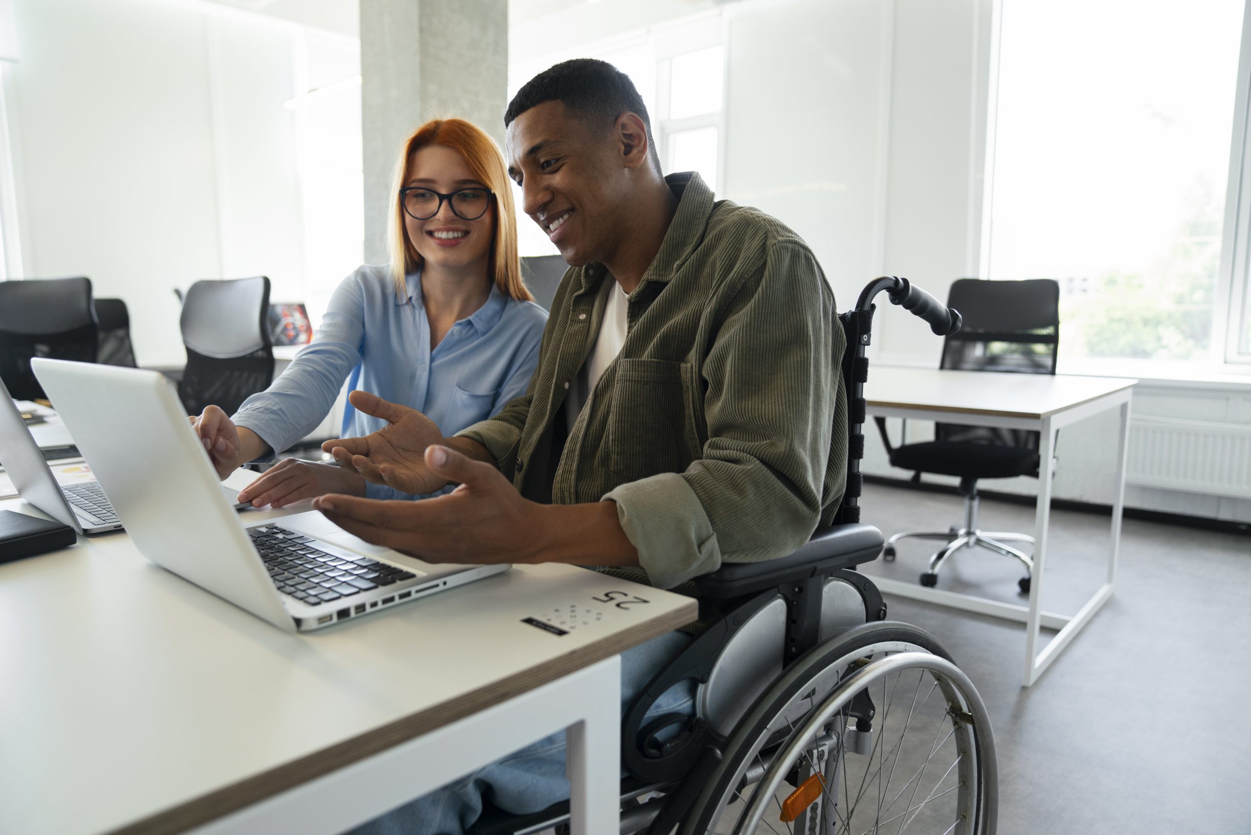 disabled-man-wheelchair-working-his-office-job